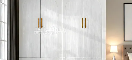 Elegant White 4-Door Wardrobe with Ribbed Detailing and Gold Handles